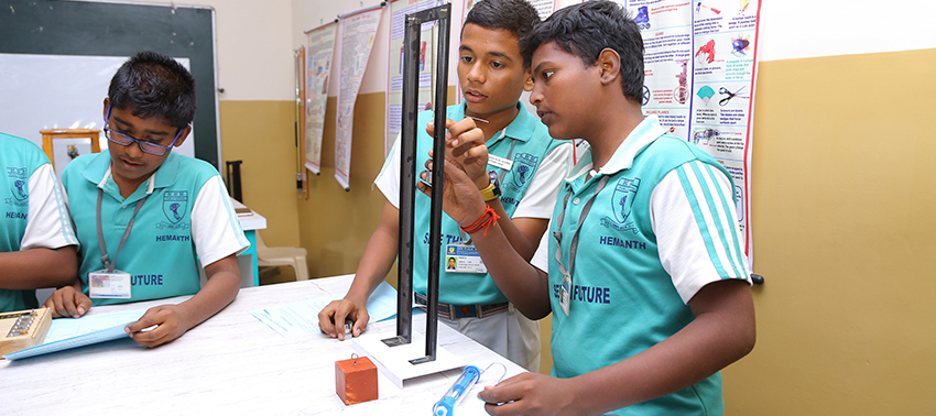 Secondary students doing a physics experiment