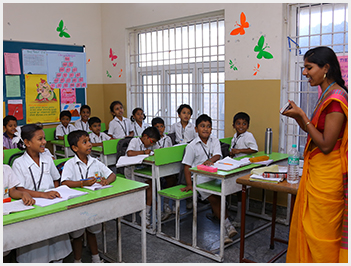 Young children listening to their teacher in a bright classroom